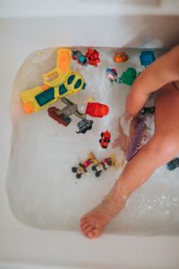 Toys floating in a bathtub. Play is a child's language, and the toys are their words. 